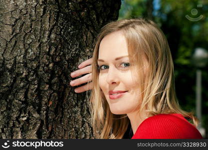 Girl cuddling a tree and dreaming - a metaphor for environmentalism