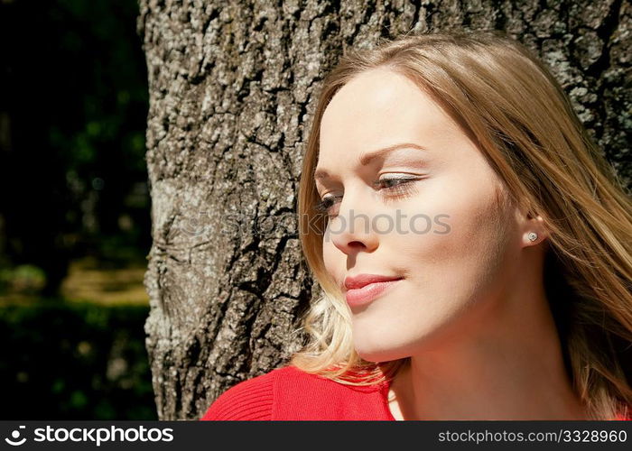 Girl cuddling a tree and dreaming - a metaphor for environmentalism