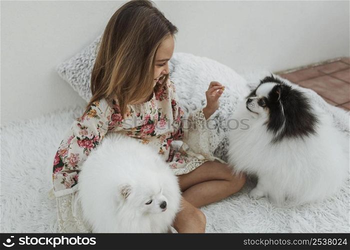 girl cute white puppies sitting bed