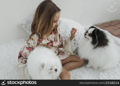 girl cute white puppies sitting bed