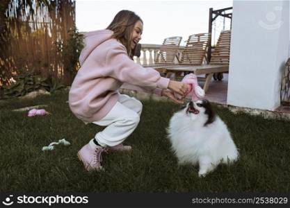 girl dog playing outdoors