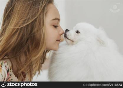 girl dog touching noses