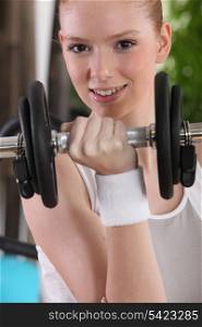 girl doing exercises with a dumbbell