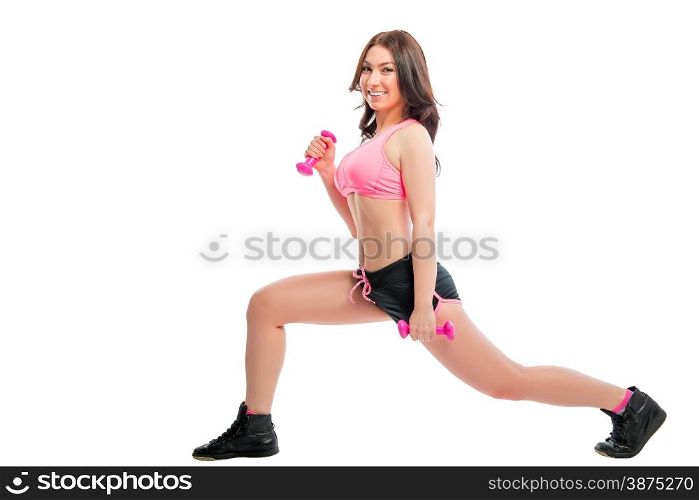 girl doing exercises with dumbbells in the studio