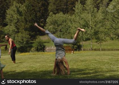 Girl doing flips on grass