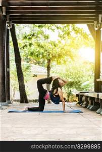 Girl doing yoga and quadricep stretching fitness, Woman doing quadriceps yoga outdoors, Stretching Yoga Concept