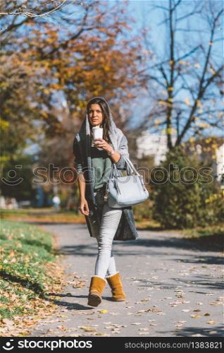 Girl drinking coffee in park