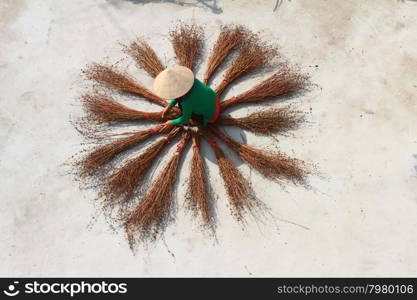 Girl drying brooms