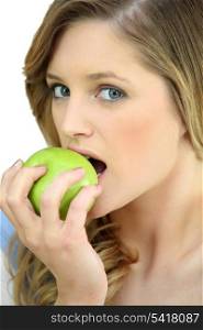 Girl eating a crisp green apple