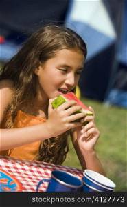 Girl eating a slice of watermelon