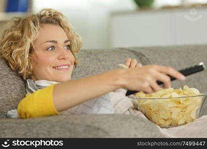 girl eating chips and watching tv