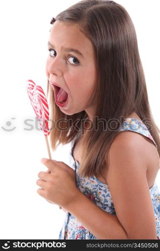 Girl eating heart lolly pop