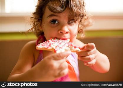 Girl eating star shaped cookie