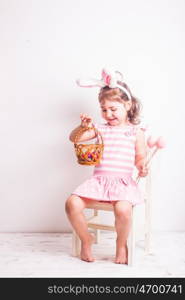 Girl eats a chocolate little eggs after Easter hunting. Girl eats a chocolate eggs