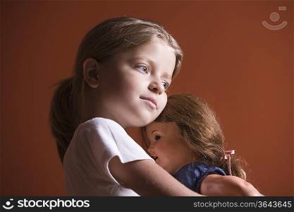 Girl embracing doll