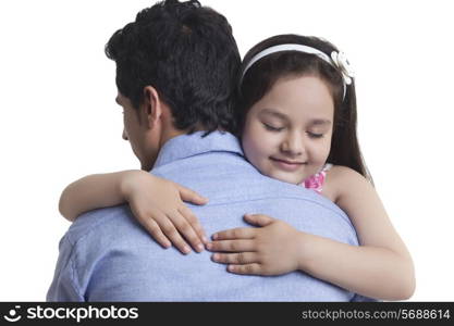 Girl embracing father over white background