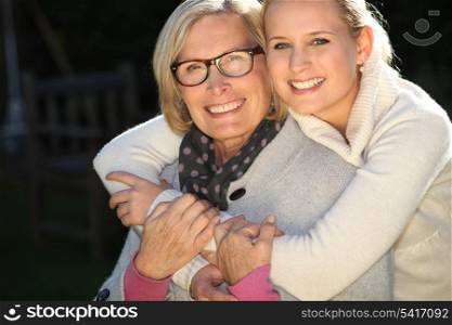 Girl embracing her grandmother