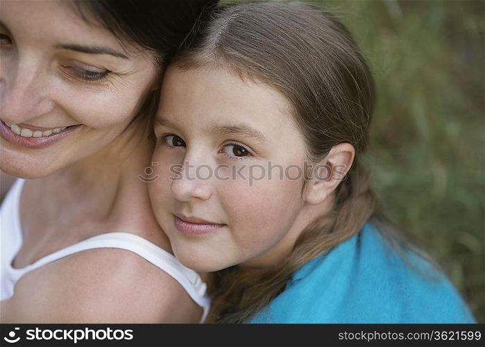 Girl embracing her mother, close-up