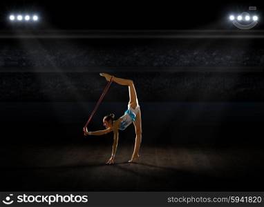 Girl engaged art gymnastic at sports hall