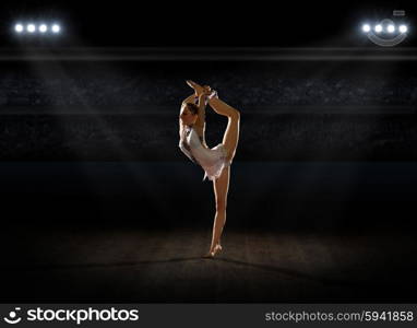 Girl engaged art gymnastic at sports hall