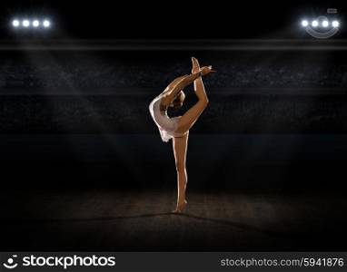 Girl engaged art gymnastic at sports hall