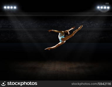 Girl engaged art gymnastic at sports hall