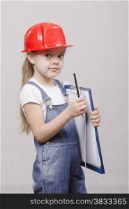 Girl engineer is a helmet folder and pencil