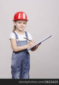 Girl engineer is a helmet folder and writes in folder