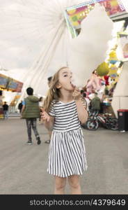 girl enjoying cotton candy