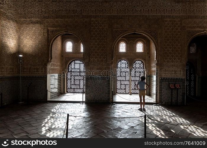 Girl enjoying the light of the Alhambra in Granada inside the Comares Palace.. Girl enjoying the light of the Alhambra in Granada.