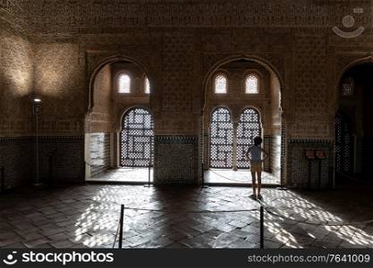 Girl enjoying the light of the Alhambra in Granada inside the Comares Palace.. Girl enjoying the light of the Alhambra in Granada.