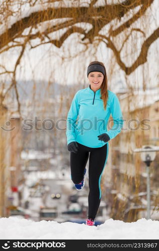 Girl exercising in city. Winter sports, outdoor fitness, fashion, urban workout, health concept.. Winter sports, girl exercising in city