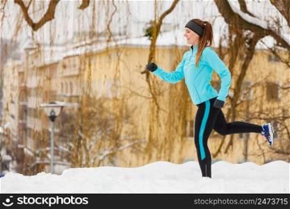 Girl exercising in city. Winter sports, outdoor fitness, fashion, urban workout, health concept.. Winter sports, girl exercising in city