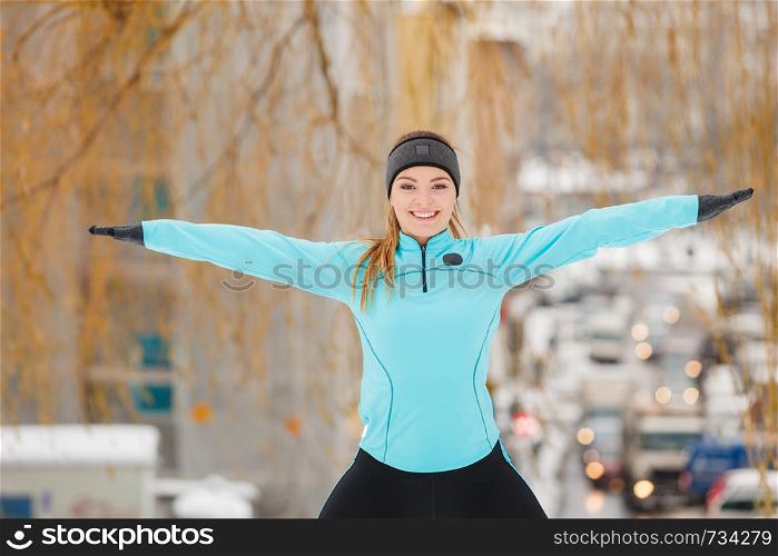 Girl exercising in city. Winter sports, outdoor fitness, fashion, urban workout, health concept.. Winter sports, girl exercising in city