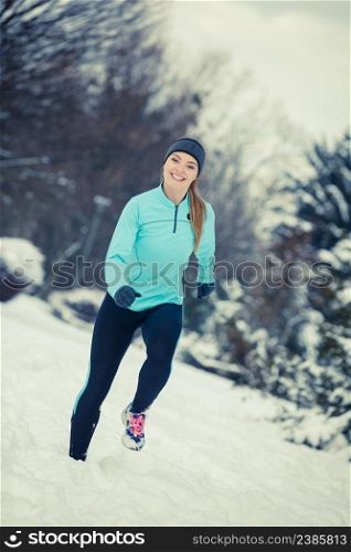 Girl exercising in park, front view. Winter sports, outdoor fitness, fashion, nature workout, health concept.. Winter sport, girl exercising in park