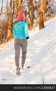 Girl exercising in winter, keeping your routine when snow comes, fitness fashion nature health concept. Girl exercising in winter