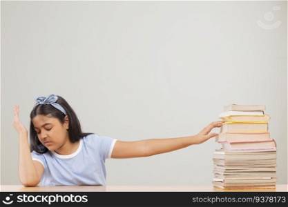 Girl expressing reluctance while sitting beside a stack of books