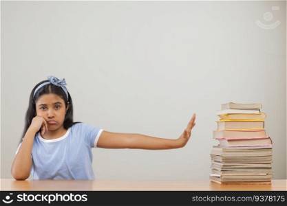 Girl expressing reluctance while sitting beside a stack of books