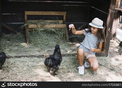 girl feeding hens farm