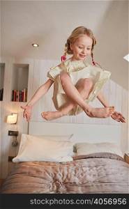 Girl floating above bed