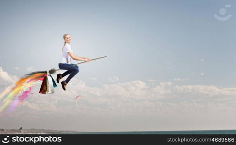 Girl fly on broom. Happy young woman flying in sky on broom