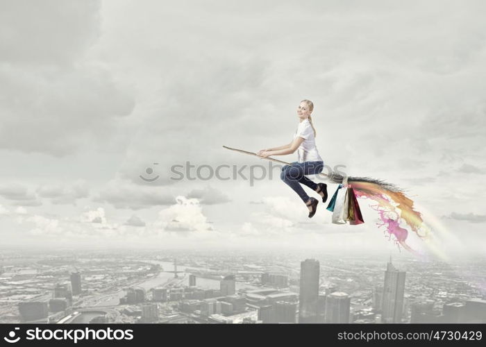 Girl fly on broom. Happy young woman flying in sky on broom