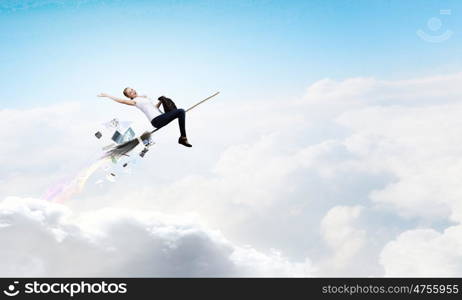 Girl fly on broom. Happy young woman flying in sky on broom