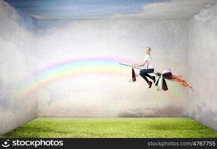 Girl fly on broom. Happy young woman flying in sky on broom