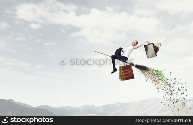 Girl fly on broom. Happy young woman flying in sky on broom