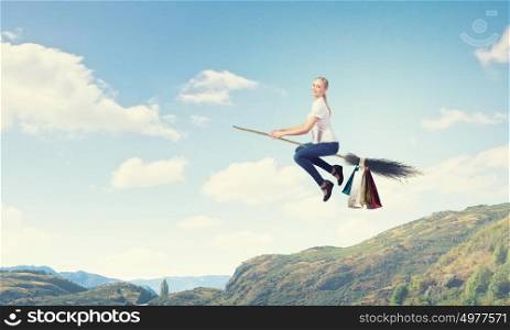 Girl fly on broom. Happy young woman flying in sky on broom