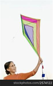 Girl flying a kite and smiling