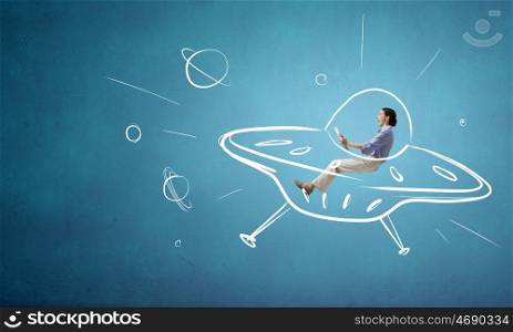 Girl flying in spaceship. Funny image of woman flying in drawn spaceship