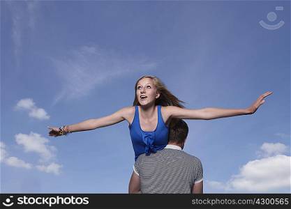 Girl flying on boys shoulders