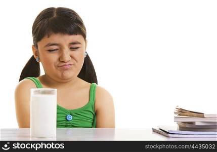 Girl fussing over a glass of milk